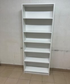 A white bookcase that looks similar to an IKEA BILLY bookcase or other comparable multi-shelf storage units. - Image 4