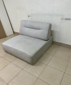 A modern, upholstered seat or chair unit without armrests, featuring an adjustable or split backrest,