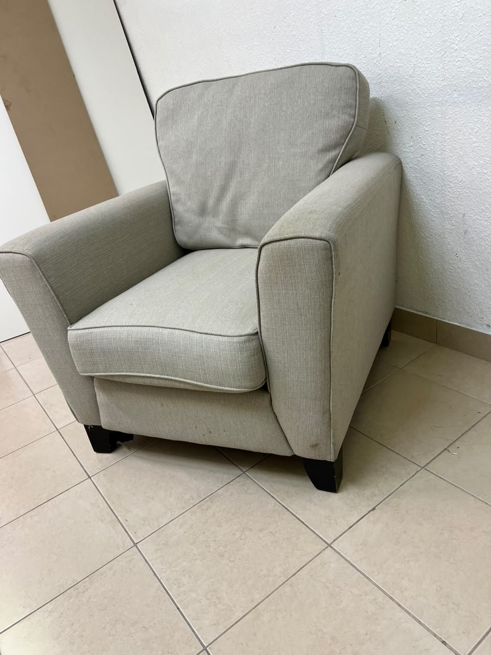 A single-seater fabric armchair in beige or light gray, featuring a separate seat cushion and back cushion, along with small black legs. - Image 6