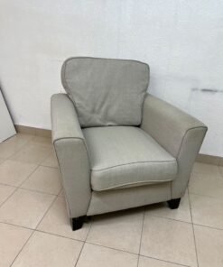 A single-seater fabric armchair in beige or light gray, featuring a separate seat cushion and back cushion, along with small black legs. - Image 9