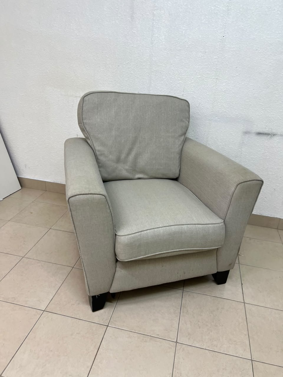A single-seater fabric armchair in beige or light gray, featuring a separate seat cushion and back cushion, along with small black legs. - Image 9