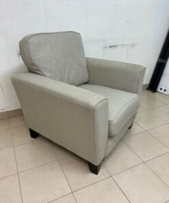 A single-seater fabric armchair in beige or light gray, featuring a separate seat cushion and back cushion, along with small black legs. - Image 3