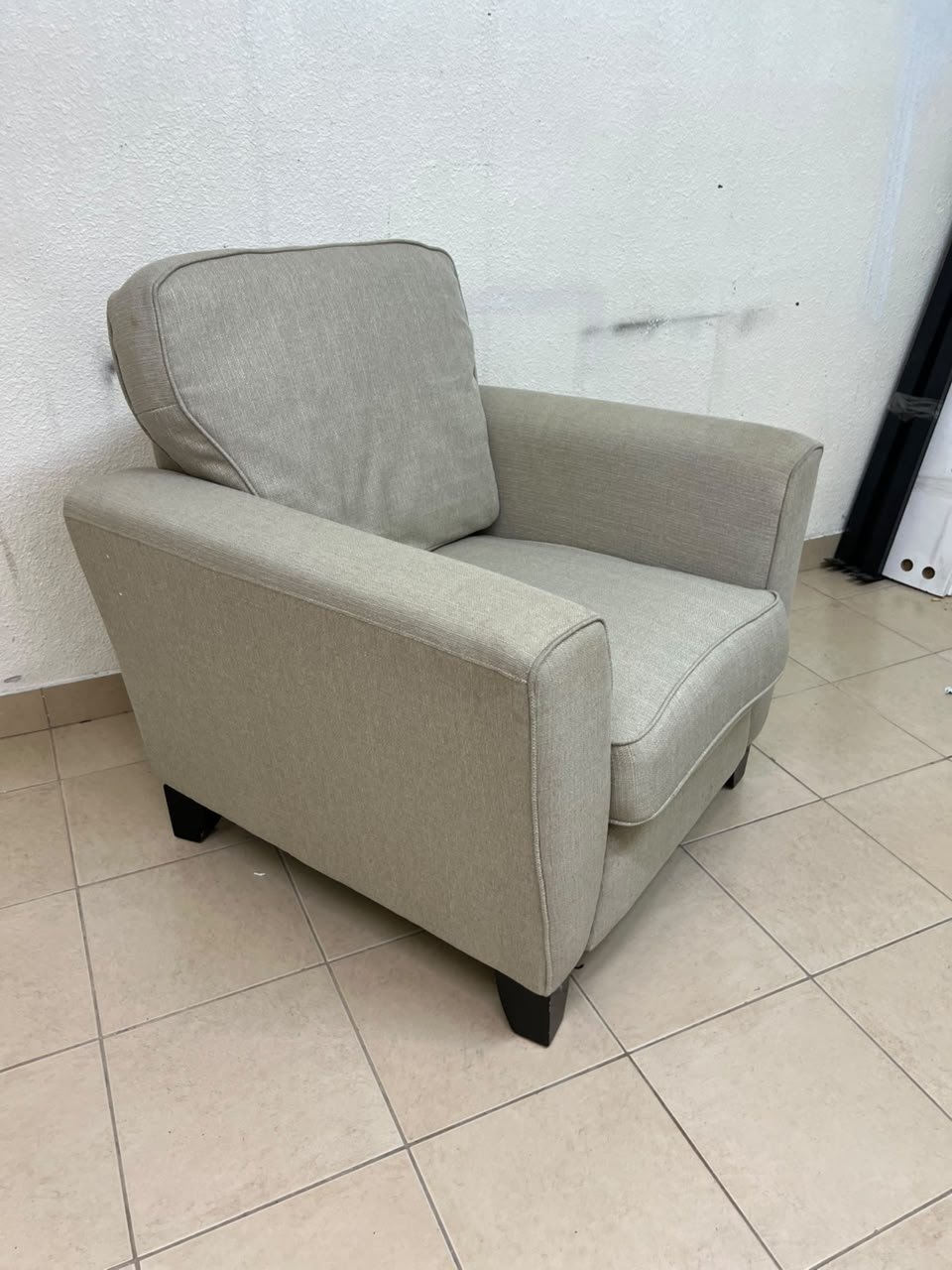 A single-seater fabric armchair in beige or light gray, featuring a separate seat cushion and back cushion, along with small black legs. - Image 3