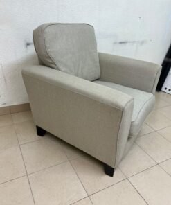 A single-seater fabric armchair in beige or light gray, featuring a separate seat cushion and back cushion, along with small black legs. - Image 4