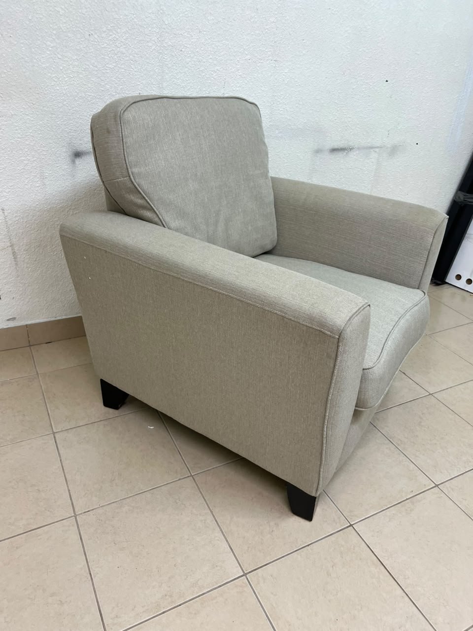 A single-seater fabric armchair in beige or light gray, featuring a separate seat cushion and back cushion, along with small black legs. - Image 4