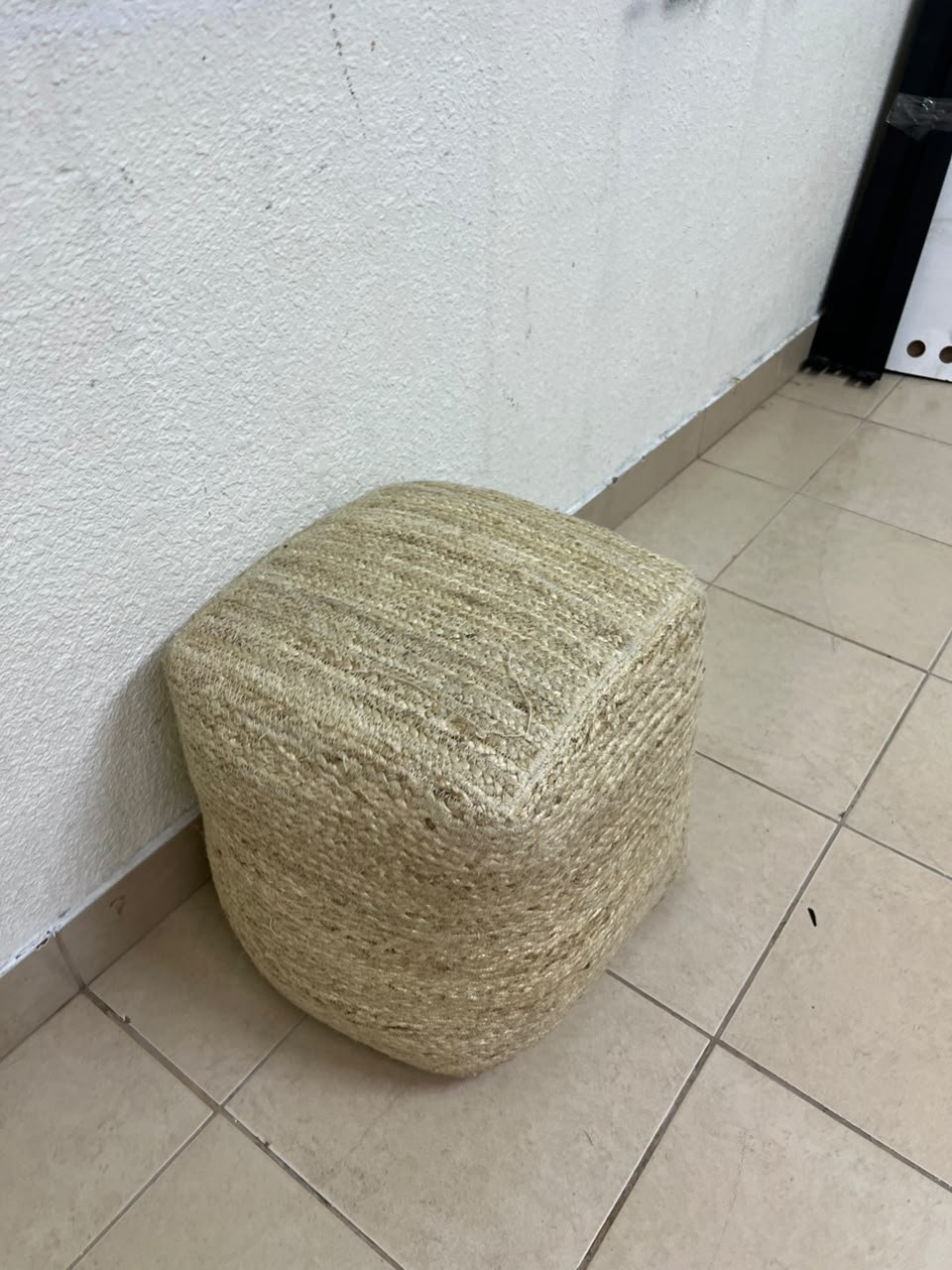 A square-shaped pouf made from braided natural jute fibers. - Image 5