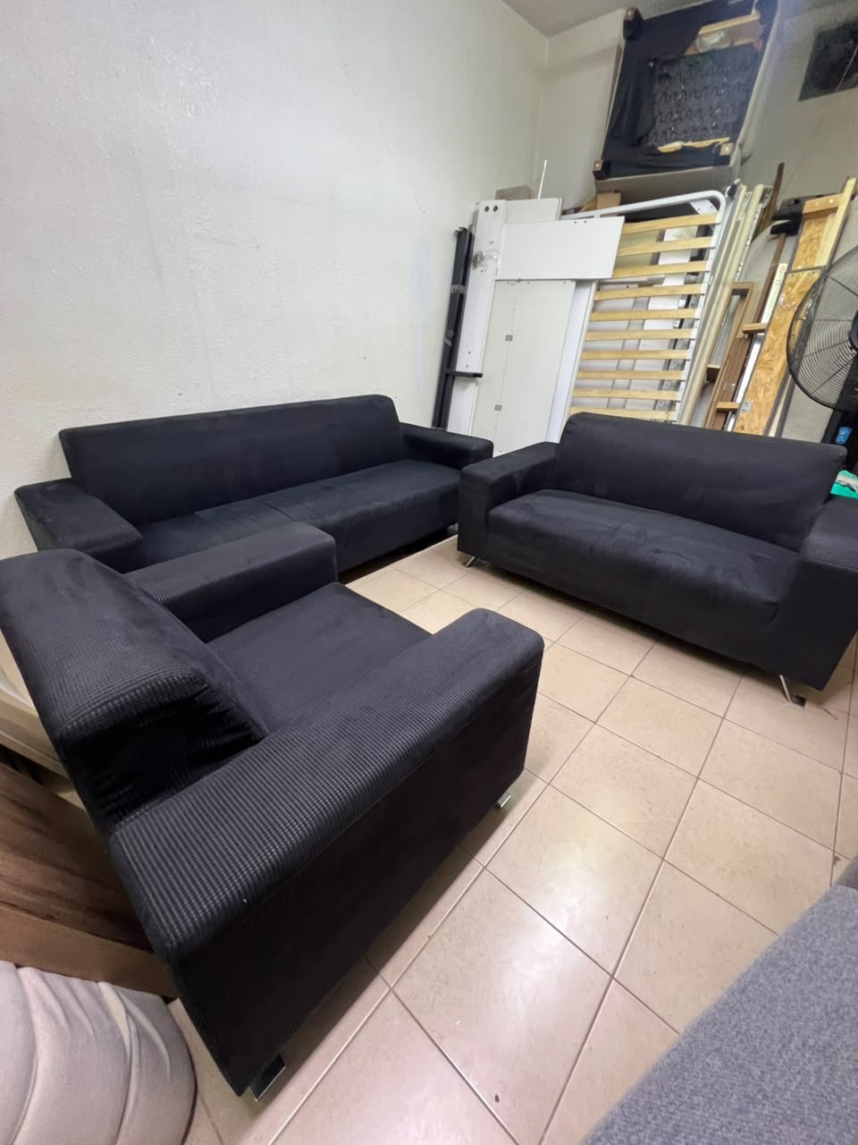 A black sofa set consisting of a large sofa (3-seater), a medium sofa (2-seater), and an armchair (1-seater), featuring wide armrests and modern metal legs. From Home Centre. - Image 8