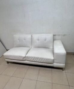 A white faux-leather sofa with a modern design, featuring button-tufted back cushions and slender metal legs. - Image 8