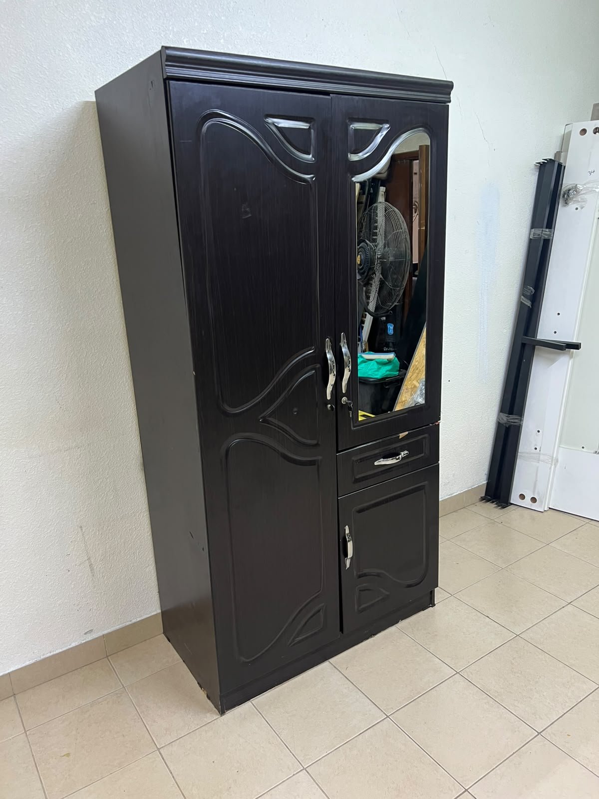 A dark brown (wenge-colored) wooden wardrobe featuring two doors—one of which has an upper mirror—along with a central drawer and a small cabinet (door) at the bottom. - Image 13