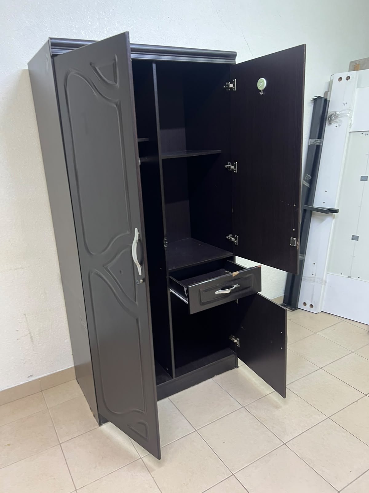 A dark brown (wenge-colored) wooden wardrobe featuring two doors—one of which has an upper mirror—along with a central drawer and a small cabinet (door) at the bottom. - Image 4