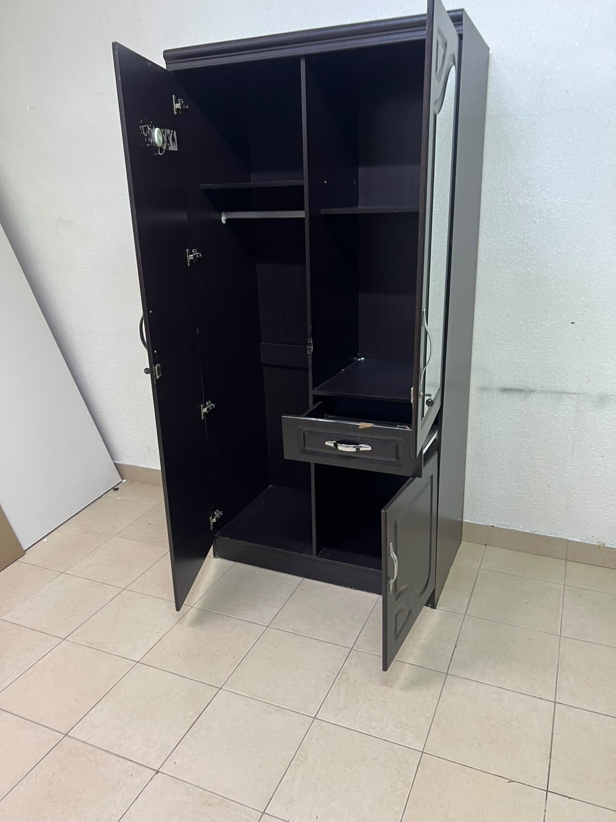 A dark brown (wenge-colored) wooden wardrobe featuring two doors—one of which has an upper mirror—along with a central drawer and a small cabinet (door) at the bottom. - Image 3